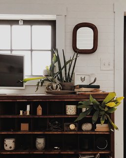 The shelves are decorated with handmade ceramics from the couple's pottery business.