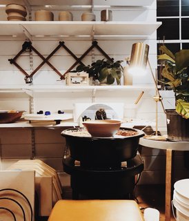 A pottery wheel and kiln form the centerpiece of the studio.