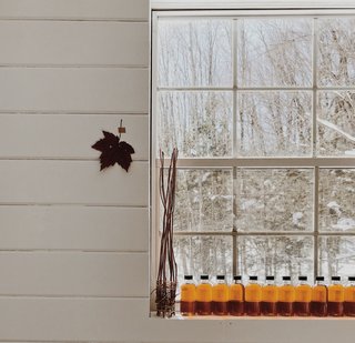 Bottled maple syrup line the windowsill in the couple's new pottery studio.