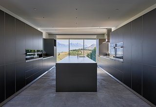 Bulthaup kitchen cabinets are complemented with quartzite and stainless steel countertops.