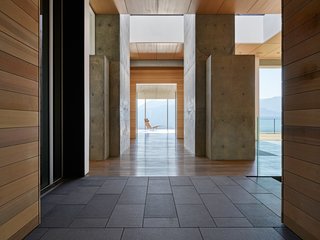 The east-west axis passes through the entry foyer and culminates in a cantilevered glass study.
