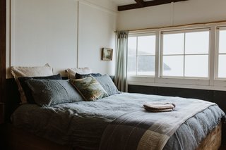 In the main bedroom, the couple have built the king-size bed frame out of recycled timber.