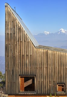 The exterior is cladded with tun timber, a wood that is native to the region. 