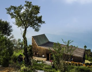The peaked roofline mimics the mountains beyond.