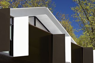 The roof overhang is painted white to bounce more light indoors.
