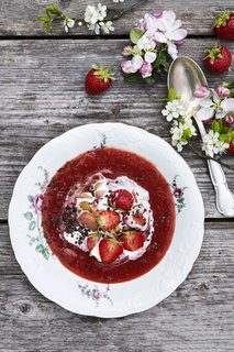 A pudding of an assortment of locally foraged summer strawberries served with cream.