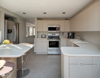 The kitchen enjoys south-facing light and direct access to the garden.