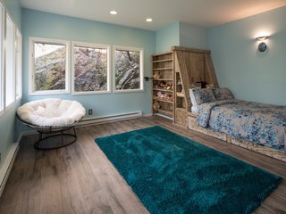 The northeast bedroom is built into Gyp Rock and comes with a handmade, white-oak built-in bed, as well as a private entrance to a small deck.