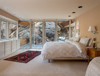 Gyp Rock is a standout feature in the upper-level master bedroom, which connects to a deck built on the moss rock.
