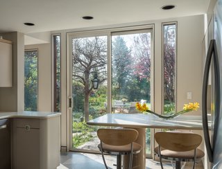 A breakfast nook in the kitchen faces a serene garden.