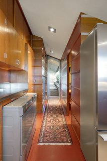 The glass-and-aluminum door is angled to match the angle of the roof gable.