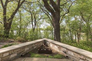 The Neils House overlooks the area's serene Cedar Lake, as well as a wooded swath of city-owned parkland.