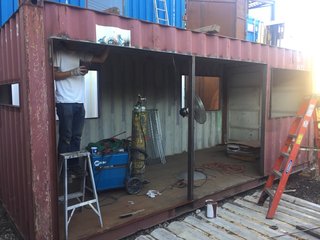 A before image of the used shipping container during the initial phases of its transformation.
