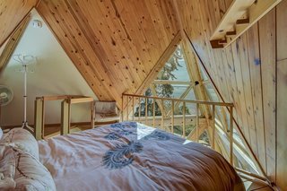 The loft, accessible via ladder in the kitchen, houses a second bedroom.