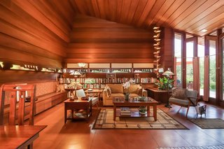 The Whiteford-Haddock House features an L-shaped design based on a two-by-four rectangular module. Pictured is the great room, which is lined with horizontal redwood panels and built-in furnishings.