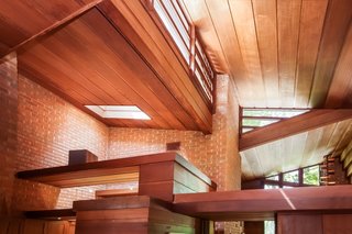 Clerestory windows and skylights, as seen in the hallway, bring light into the living spaces.