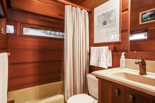 The bathroom is located next to the entrance.