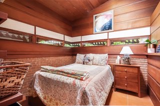 The second bedroom has perforated boards installed at eye level.