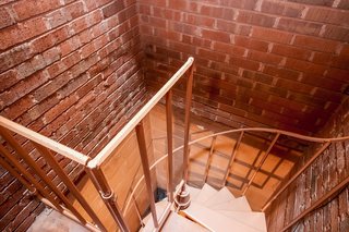 A spiral staircase leads to the basement utility room and laundry room.