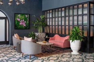 A fluted glass partition separates an intimate lounge area adjacent the front lobby from the main public space.