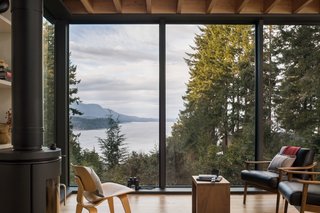 Full-height windows blur the distinction between indoor and outdoors in the living area.