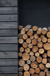 Firewood is neatly stacked in a built-in storage space on the south side of the home.