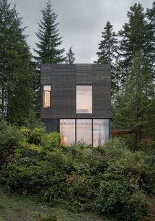Large windows punctuate the north elevation to pull views of the the water and landscape indoors.