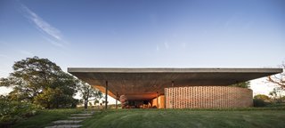 The structure is built entirely of reinforced, poured in-situ concrete, except for the metallic pillars on opposite ends of the home.