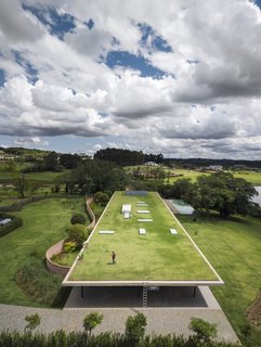 The green roof is accessible via ladder. "This type of insertion on the plot demanded care and attention with the design of the rooftop, which is the fifth facade of the building," adds the architects.
