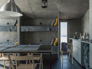 The living area and sleeping spaces are placed on the south side, while the compact kitchen and bathroom (hidden behind the kitchen) are located to the north.