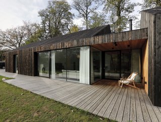 Large windows and terraces connect the home to the outdoors.