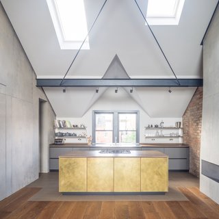 Sola Kitchens designed Mandy and Ivan’s luxurious kitchen, which features a brass-fronted island, a vintage oak worktop, and stained oak cabinetry.