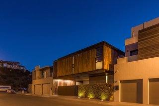 Casa Ga2 seen at night with a closed entrance gate. 