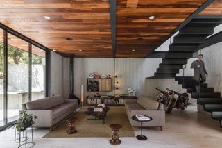 A minimalist staircase links the living room to the upper level.