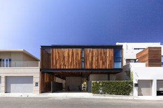 Casa Ga2 stands out from its neighbors with its facade clad in vertical timber.