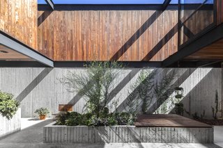The courtyard is open to the sky and mainly finished in concrete.
