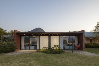 Sliding glass doors open the bedrooms to their own private patios; the opaque walls conceal the bathrooms.
