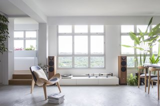 By removing the walls of a former bedroom, the architects have created a more spacious living room that is now flooded with natural light and views.