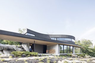 The horizontal plane that rests atop concrete load-bearing walls has been extended to protect the interior from solar gain and provide shelter to the outdoor living areas.
