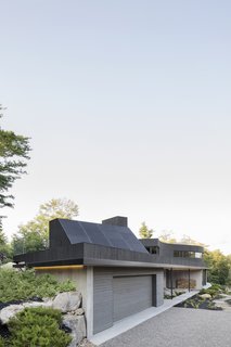 Photovoltaic panels have been installed on the sloped, south-facing volume.