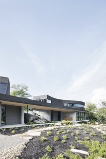 The architects have installed ample glazing along the south facade, particularly on the lower level, to take advantage of solar gain in the winter. The concrete floors also help retain heat.
