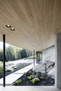 "Below the horizontal plane, it was decided to reorganize the site in order to design a plateau that would become the outdoor living plane," says the firm. "The blasting residues were compacted and refused on the site to create the project’s new ground: a disturbed surface rather than one extracted from the territory."