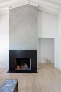 A wood-burning fireplace anchors the living room in the bungalow.