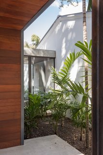A glazed vestibule connects the new addition with the renovated bungalow.