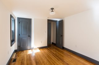 A look inside the renovated second bedroom, which comes with its own bathroom. Yellow pine now lines the floors.