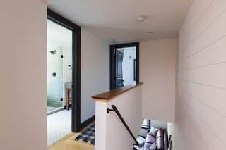 White shiplap continues from the first floor to the second, which houses the two bedrooms.