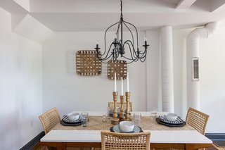Woven grass textures and intimate lighting fixtures create a cozy atmosphere at the dining table. Lighting was sourced from Anthropologie, Pottery Barn, and World Market.