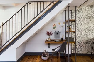 A small workspace now takes advantage of the cozy nook beneath the stairs.