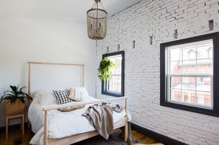 The brick wall was exposed in the master bedroom for an extra pop of texture.
