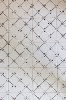 A close up of the dainty tile floors in the revamped bath.